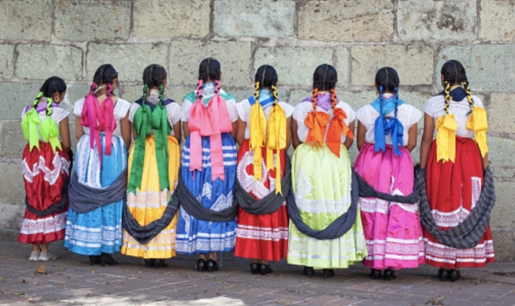 Colourful wedding dancers pose for a photo at the Basilica of Our Lady of Solitude Church in the City of Oaxaca, Mexico.